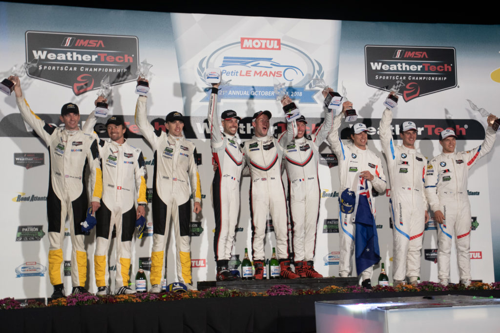 (Left to Right) Oliver Gavin,Marcel Fassler, Tommy Millner, Frédéric Makowiecki, Nick Tandy, Patrick Pillet, Chaz Mostert, Jon Edwards, Jesse Krohn Celebrate on the GT Le Mans Podium at Road Atlanta. Photo By Eric Cumbee