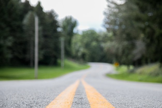 closeup-shot-empty-road-with-blurred-distance_181624-26410