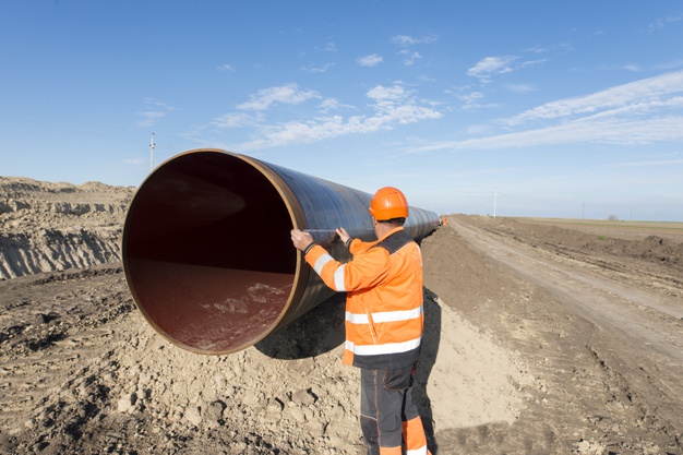 pipeline-workers-measuring-tube-length-construction-gas-oil-pipes_342744-48