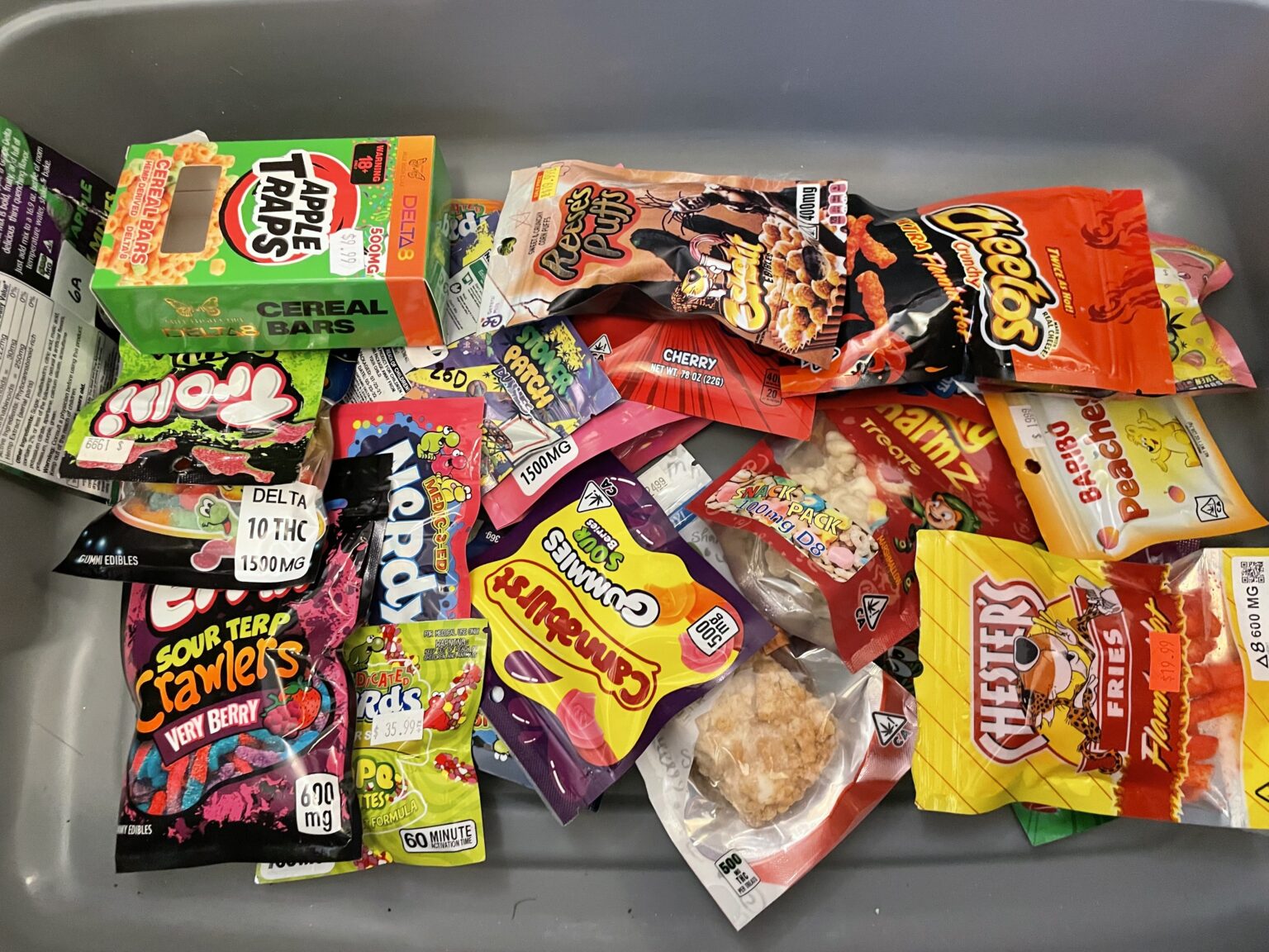 Attorney General Jason Miyares displayed a bin of THC edible products from Virginia stores. Experts say the products have caused a spike in poison control calls involving young children and teens. (Photo by Graham Moomaw)